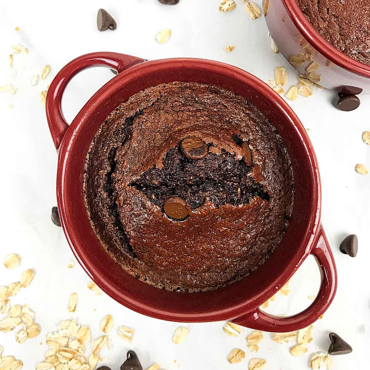 top view of a chocolate baked dessert in a red ramekin