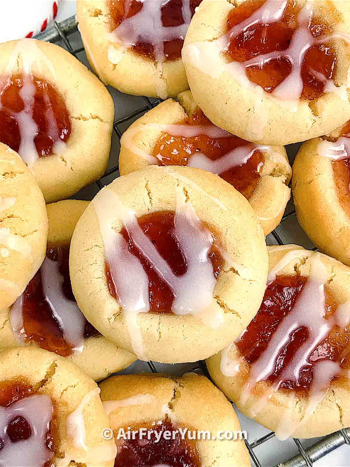Top view of a collection of jam filled cookies topped with glaze