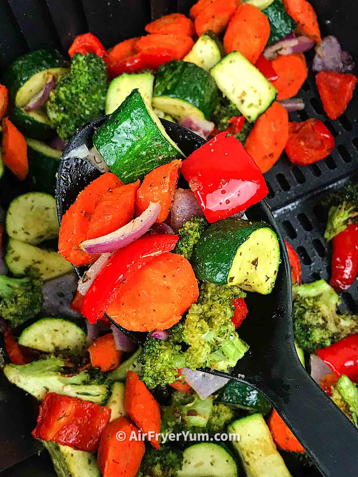 vegetables including onions, zucchini, red bell peppers and broccoli
