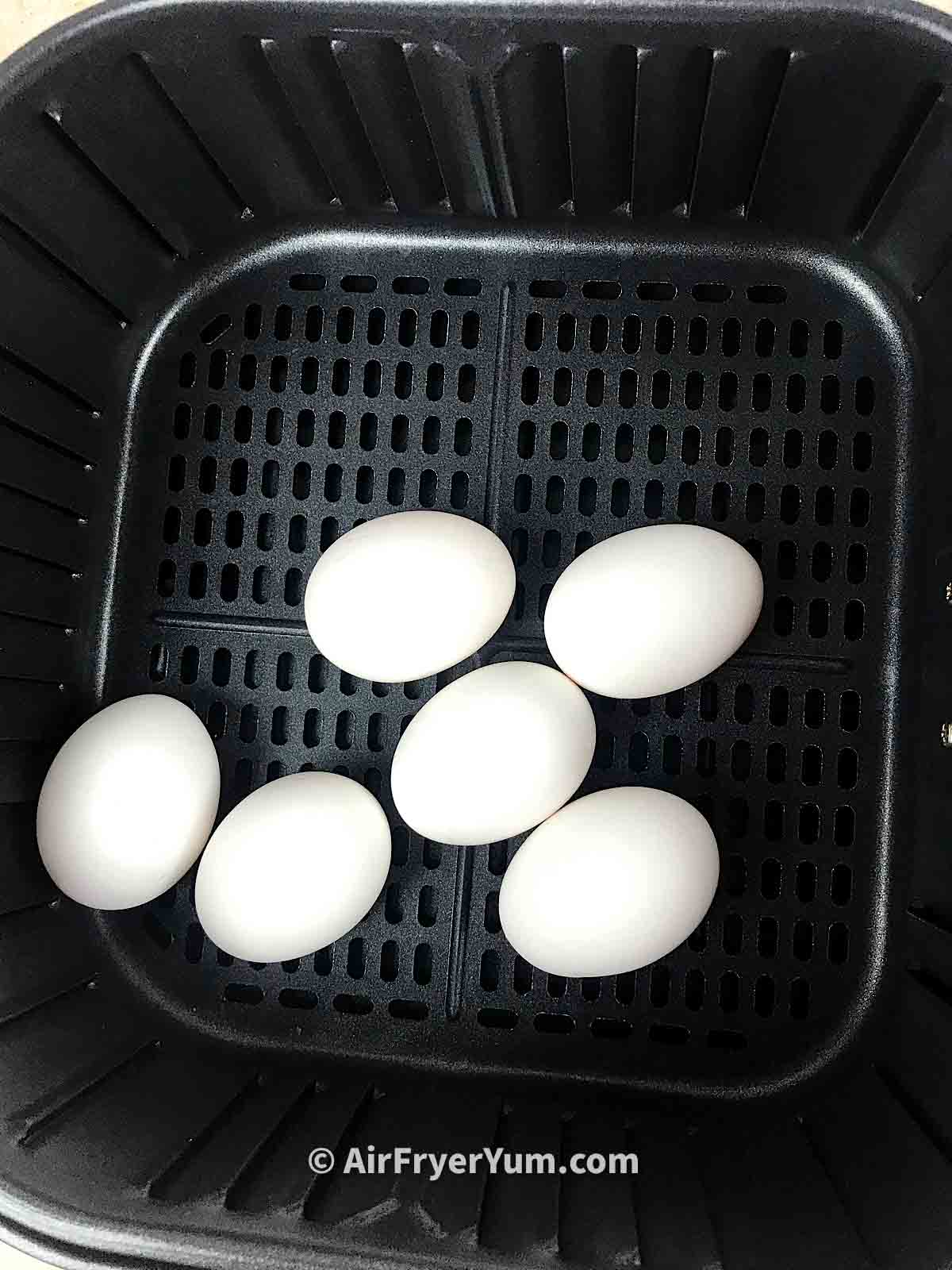 White eggs in air fryer basket 